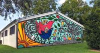 Rendering of proposed mural with whimsical birds, houses, and a tree